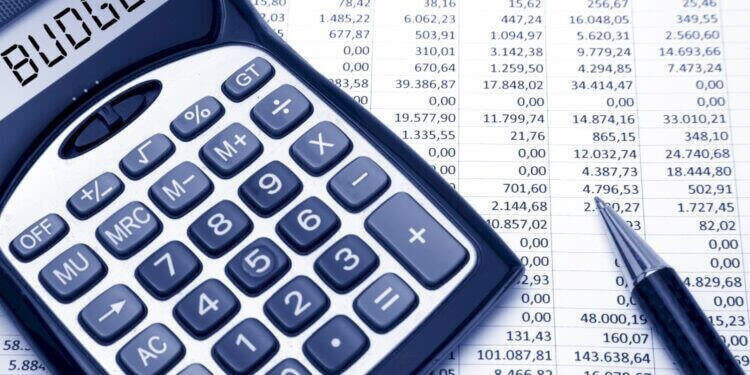 calculator with operational costs budget on screen